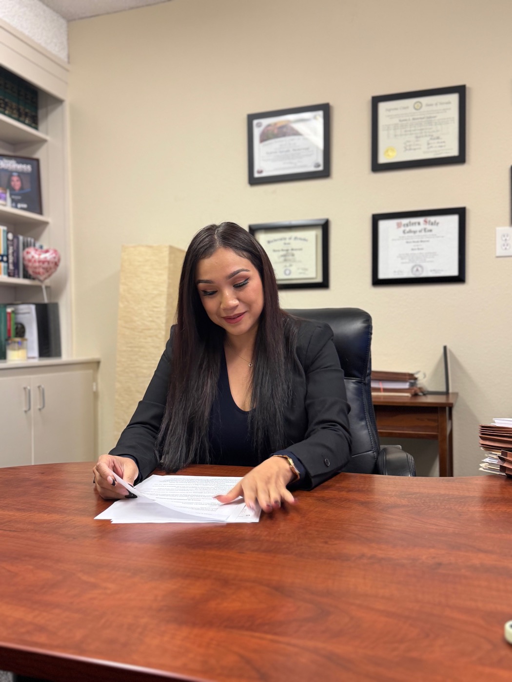 Attorney Karen S. Monrreal reviewing a case file at her desk in Reno